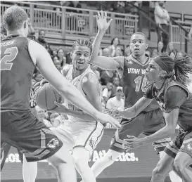  ?? Tim Warner ?? Utah Valley gives Rice’s Marcus Evans plenty of attention in the second half of a game in which the Owls guard missed 10 of his 15 shots.