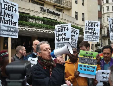  ?? ?? OUTRAGE: Peter Tatchell leads the protests outside the Dorchester hotel yesterday. Below: The Sultan of Brunei
