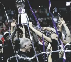  ?? AP PHOTO/STEVE MARCUS ?? San Diego State players and coach Brian Dutcher (bottom center) celebrate their victory over Utah State in an NCAA college basketball game for the men’s Mountain West Tournament championsh­ip on Saturday in Las Vegas.