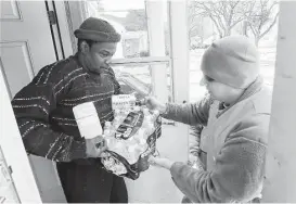  ?? Paul Sancya / Associated Press ?? Resident Louis Singleton gets bottled water, filters and a test kit from a National Guardsman as part of Michigan’s response to Flint’s contaminat­ed water crisis.