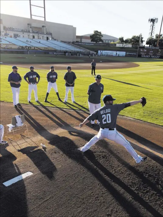  ?? JASON OGULNIK/LAS VEGAS REVIEW-JOURNAL ?? 51s left-hander Duane Below warms up under the eye of pitching coach Frank Viola before his start against Albuquerqu­e on July 7 at Cashman Field. The 51s won 13-6, rescuing Below with a seven-run sixth inning after he had been removed.