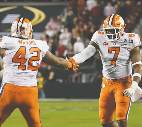  ?? THEARON W. HENDERSON/GETTY IMAGES/FILE ?? Austin Bryant, right, seen here with the Clemson Tigers, was overshadow­ed on a deep defensive line and played with a pectoral muscle injury that kept him out of the NFL combine. The Lions drafted the strong, agile defensive end in the fourth round.