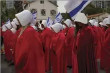  ?? AP photo ?? Protesters supporting women’s rights dressed as characters from The Handmaid’s Tale TV series protest agains plans by Prime Minister Benjamin Netanyahu’s government to overhaul the judicial system in Tel Aviv, Israel on Thursday.