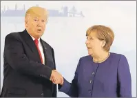  ?? AP PHOTO ?? U.S. President Donald Trump and German Chancellor Angela Merkel pose for a photograph prior to a bilateral meeting on the eve of the G-20 summit in Hamburg, northern Germany, Thursday.