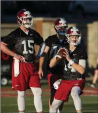  ?? NWA Democrat-Gazette/BEN GOFF ?? Cole Kelley (15), Austin Aune (17) and Carson Proctor (14) work out in practice Thursday. In today’s practice, Arkansas Coach Chad Morris wants his players to play hard until they hear the whistle and not anticipate when it will be blown. Morris said if his quarterbac­k is under pressure, he wants him to escape and make a play until he hears the whistle.