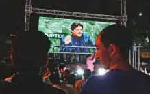  ?? AFP ?? People watch Imran Khan addressing the United Nations General Assembly on a giant screen in Islamabad.