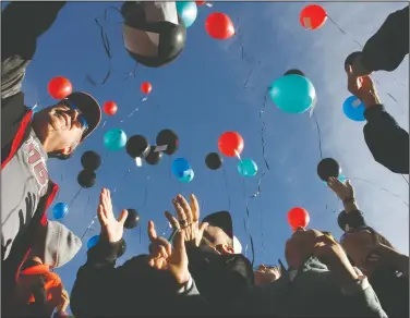  ?? Photo by Terrance Armstard/News-Times ?? Release: Friends, family and colleagues gather to remember Ryan Burns at El Dorado Golf and Country Club on Saturday. Burns was a member of the KidsNGolf organizati­on. Balloons were released in memory of Burns who died earlier this month.