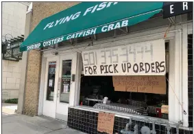  ?? (Arkansas Democrat-Gazette/Eric E. Harrison) ?? The Flying Fish on President Clinton Avenue in the River Market takes walk-up orders through its garage-door-style front window.