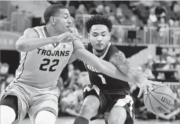  ?? Photograph­s by Ethan Miller Getty Images ?? USC GUARD De’Anthony Melton (22) tries to steal the ball from Washington guard David Crisp.