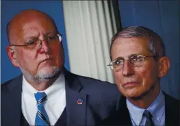  ?? GETTY IMAGES ?? Robert Redfield, left, said Thursday the CDC won’t revise its coronaviru­s guidelines for reopening schools. Dr. Anthony Fauci, right, said he thinks hot spots can contain them by pausing their reopening processes rather than shutting down again.