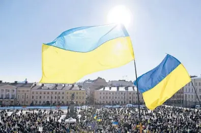  ?? VESA MOILANEN/LEHTIKUVA/GETTY-AFP ?? Ukrainian flags are seen March 12 at Helsinki Senate Square in Helsinki, Finland.