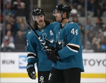  ?? NHAT V. MEYER — BAY AREA NEWS GROUP ?? San Jose Sharks’ Erik Karlsson (65) talks with teammate Marc-edouard Vlasic (44) during a game in 2019.