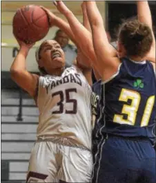  ?? PETE BANNAN — DIGITAL FIRST MEDIA ?? Bonner & Prendergas­t’s Nyah Garrison (35) puts up a shot over Notre Dame’s Maggie Pina in the second quarter Tuesday night. The Pandas lost to the Irish in overtime, 77-69, in a thriller.