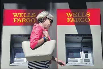  ?? Frederic J Brown AFP/Getty Images ?? LAST WEEK Wells Fargo acknowledg­ed it charged 570,000 auto-loan borrowers for insurance policies that they didn’t need, a matter that’s drawing attention from regulators and Democrats on Capitol Hill.