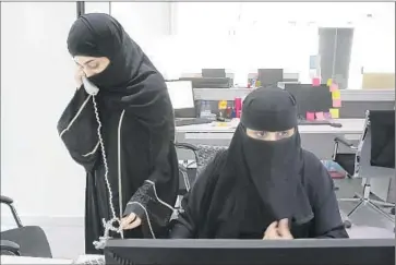  ?? Photograph­s by Carolyn Cole
Los Angeles Times ?? AT GLOWORK, Saudi women help other women find jobs. Every time a woman is placed, a gong is rung and the entire office breaks out in applause; over four years, the gong has sounded thousands of times.