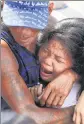  ?? AP/FILE ?? Relatives and friends grieve at the funeral of an alleged drug suspect Robert Manuel Jr. in Manila.