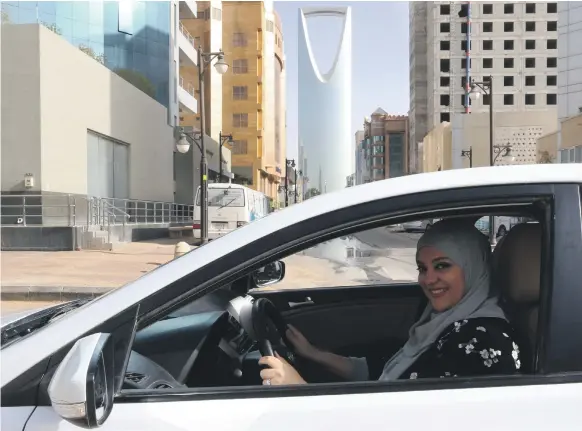  ??  ?? Dina Yousef, 30, drives through the streets of Riyadh yesterday, hours after a royal decree lifted a ban on women driving in Saudi Arabia