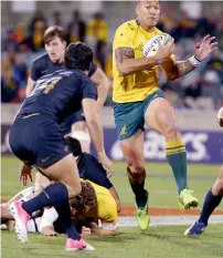  ?? AP ?? Australia’s Israel Folau (right) looks to step past Argentina’s Matias Moroni. —