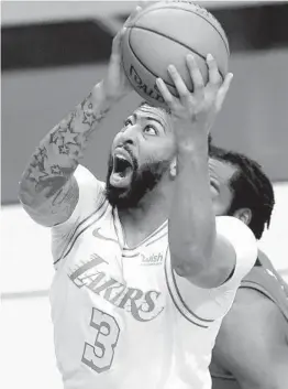  ?? CARMEN MANDATO GETTY IMAGES ?? The Lakers’ Anthony Davis, who had 27 points on 9-of-12 shooting, goes up for a basket during the second quarter against the Rockets at Toyota Center.