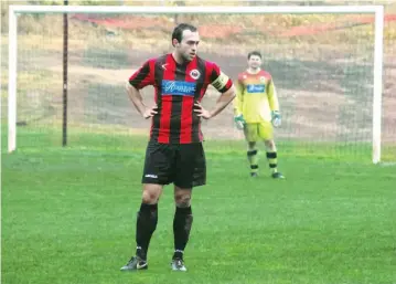  ??  ?? Warragul United skipper Matt Gauci watches the play unfold against Eltham as goal keeper Liam Andersen stands firmly between the sticks.
A wet Baxter Park made conditions difficult for both sides as players struggled to hold their feet. However, United stamped its authority early with a first half goal as its defence – led by Gauci – proved rock solid.
Photograph by Amanda Emary.