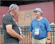  ?? Doug Walker / Rome News-Tribune ?? J.B. Barrett (left) of Columbus and David Poker of Knoxville, Tenn., compare notes in front of the bandstand at Ridge Ferry Park during Saturday’s big Going Caching Mega-Event. Barrett actually met his future wife at the 2014 event in Rome and married...