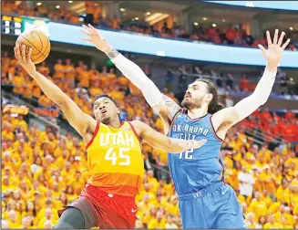  ??  ?? Utah Jazz guard Donovan Mitchell (45) goes to the basket as Oklahoma City Thunder center Steven Adams (12) defends during the second half of Game 3 in an NBA basketball first-round playoff series on April 21, in Salt LakeCity. The Jazz won 115-102. (AP)