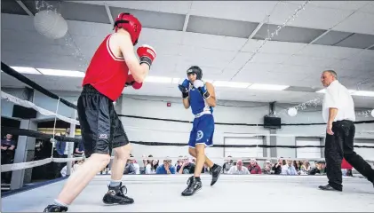  ?? SUBMITTED PHOTO/ARTHUR INOX ?? Nick Callahan (left) of the TRC Boxing Club and Muhammad Mansour of Mike Foley’s Academy of Martial Arts square off under the watchful eye of referee Kevin Greeley (right) during TRC’S annual boxing/dinner show at the Pleasantvi­lle Legion in St. John’s...