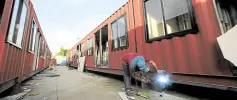  ?? —GRIG C. MONTEGRAND­E ?? OCTOBER OPENING Department of Public Works and Highways personnel rush to convert freight containers into air-conditione­d isolation rooms for coronaviru­s patients at the Navotas Centennial Park on C-4 Road.