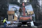  ?? TED S. WARREN — THE ASSOCIATED PRESS ?? Workers demolish the house Thursday where four University of Idaho students were killed in 2022 in Moscow, Idaho.