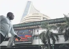  ??  ?? A man walks past the Bombay Stock Exchange (BSE) building in Mumbai, India. The Nifty Energy Index fell 6.14 per cent lower on Thursday in reaction to the news. Shares in Indian Oil Corp, the country’s biggest oil refiner, dropped 11.4 per cent. — Reuters photo