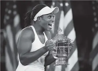  ?? ASSOCIATED PRESS PHOTOS ?? Sloane Stephens holds up the championsh­ip trophy after beating Madison Keys in the women’s singles final of the U.S. Open Saturday in New York. Stephens won 6-3, 6-0.