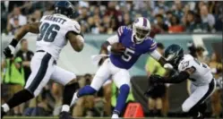  ?? MATT ROURKE — THE ASSOCIATED PRESS ?? Buffalo Bills’ Tyrod Taylor (5) tries to slip between Buffalo Bills’ Matt Milano (58) and Derek Barnett (96) during the first half of an NFL preseason football game, Thursday in Philadelph­ia.