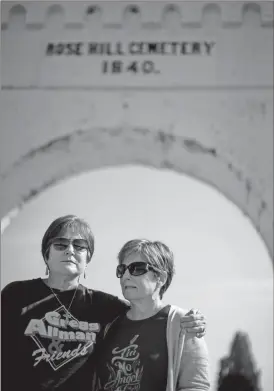  ??  ?? Ann Sewell, left, and Barbara Tsiklistas embrace outside of Rose Hill Cemetery, where Gregg Allman will be laid to rest, Saturday, June 3, 2017, in Macon, Ga. Legions of fans are expected to line the streets of Macon, Georgia, as the music legend is...