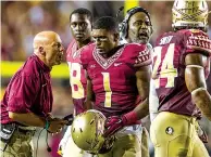  ?? Associated Press ?? n Florida State defensive coordinato­r Charles Kelly, left, talks to defensive back Tyler Hunter on Sept. 20, 2014, during the second half against Clemson in Tallahasse­e, Fla. Florida State’s defense returns nine starters to a unit that struggled the...
