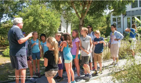  ??  ?? Volunteer Alex Werner gives children a tour of the historical complex.