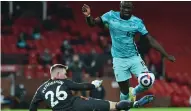  ??  ?? LIVERPOOL’S Sadio Mane evades a tackle from Manchester United’s Dean Henderson. | PETER POWELL Reuters