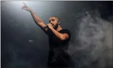  ?? JONATHAN SHORT — INVISION — AP, FILE ?? Drake performs on the main stage at Wireless festival in Finsbury Park, London in 2015. Drake could have offered Super Bowl week concertgoe­rs just a few songs, but the rapper-singer instead delivered a healthy dose of his hits.