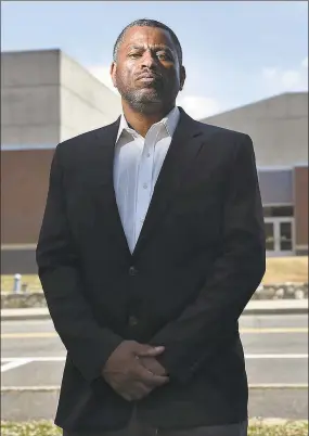  ?? Cloe Poisson / CTMirror.org ?? Brian Murray-Dalrymple moved his family to Weston eight years ago for the excellent school system for his five children. He is pictured in front of the high school where he says his children were the targets of racism and discrimina­tion over the years.