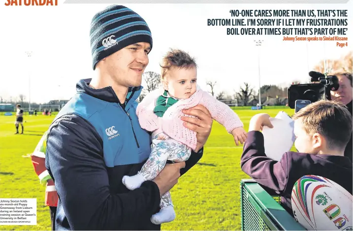  ?? OLIVER McVEIGH/SPORTSFILE ?? Johnny Sexton holds six-month-old Poppy Greenaway from Lisburn during an Ireland open training session at Queen’s University in Belfast