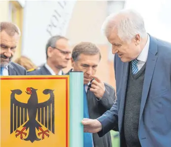  ?? FOTO: DPA ?? Horst Seehofer (CSU, re.) eröffnet das neue Fahndungs- und Kompetenzz­entrum der Polizei. Das ist seine Aufgabe als Innenminis­ter – sein Ressort hat er auch um die Felder Bauen und Heimat erweitert.