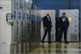  ?? EVAN VUCCI — THE ASSOCIATED PRESS FILE ?? President Joe Biden walks by freezers used to hold the Pfizer COVID-19 vaccine as he tours a Pfizer manufactur­ing site with Albert Bourla, Pfizer CEO, in Portage, Mich.