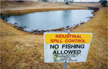  ?? STEVE SCHAEFER/SPECIAL TO THE AJC ?? Standing water collects in a spill pond on Dobbins Air Reserve Base in Marietta. The spill pond was among those impacted by contaminat­ion from a special firefighti­ng foam used by the military.