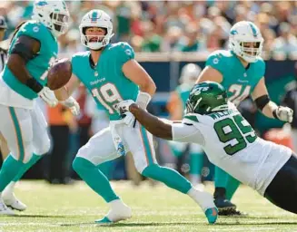  ?? ADAM HUNGER/AP ?? Jets defensive tackle Quinnen Williams pulls down Dolphins quarterbac­k Skylar Thompson during the second quarter on Oct. 9 in East Rutherford, N.J.