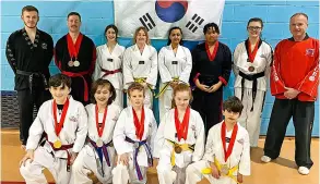  ?? ?? Bath TKD coach James Tolfree (left), Master Rob Morris (right) and the competitor­s at the South West Championsh­ips