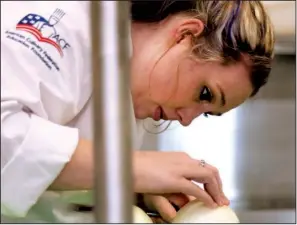  ?? Arkansas Democrat-Gazette/JOHN SYKES JR. ?? Culinary arts student Ruthie Murphy tries her hand at cutting an onion at Pulaski Technical College in Little Rock. She hopes the training will lead to having her own restaurant.