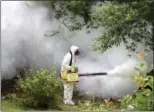  ?? AP FILE ?? Bobby Kitchens, an employee of Richmond County Ga., Mosquito Control, sprays insecticid­e in the backyard of an abandoned home in Augusta, Ga., in August 2016.