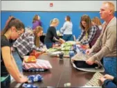  ?? SUBMITTED PHOTO ?? Sheetz employees wrap presents in December to be given to children during holiday parties across the state as part of Sheetz for the Kidz charity program.