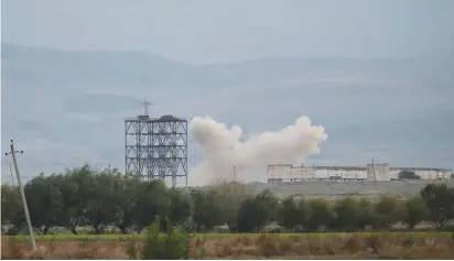  ?? ( Umit Bektas/ Reuters) ?? SMOKE RISES as Azerbaijan’s forces shell targets during the fighting over the breakaway region of Nagorno- Karabakh near Terter earlier this week.