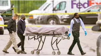  ?? MICHAEL CONROY/AP ?? A body is taken Friday from the scene where multiple people were shot, eight fatally, at a FedEx Ground facility in Indianapol­is.