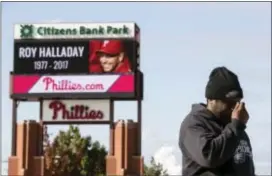  ?? MATT ROURKE — THE ASSOCIATED PRESS ?? Michael Aikens crosses himself as he pays his respects outside Citizens Bank Park at a makeshift memorial for former Phillies pitcher Roy Halladay in Philadelph­ia, Wednesday. Halladay, a two-time Cy Young Award winner who pitched a perfect game and a...